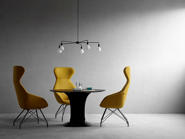 Chaises de réunion jaunes autour d'une table ronde noire, design contemporain